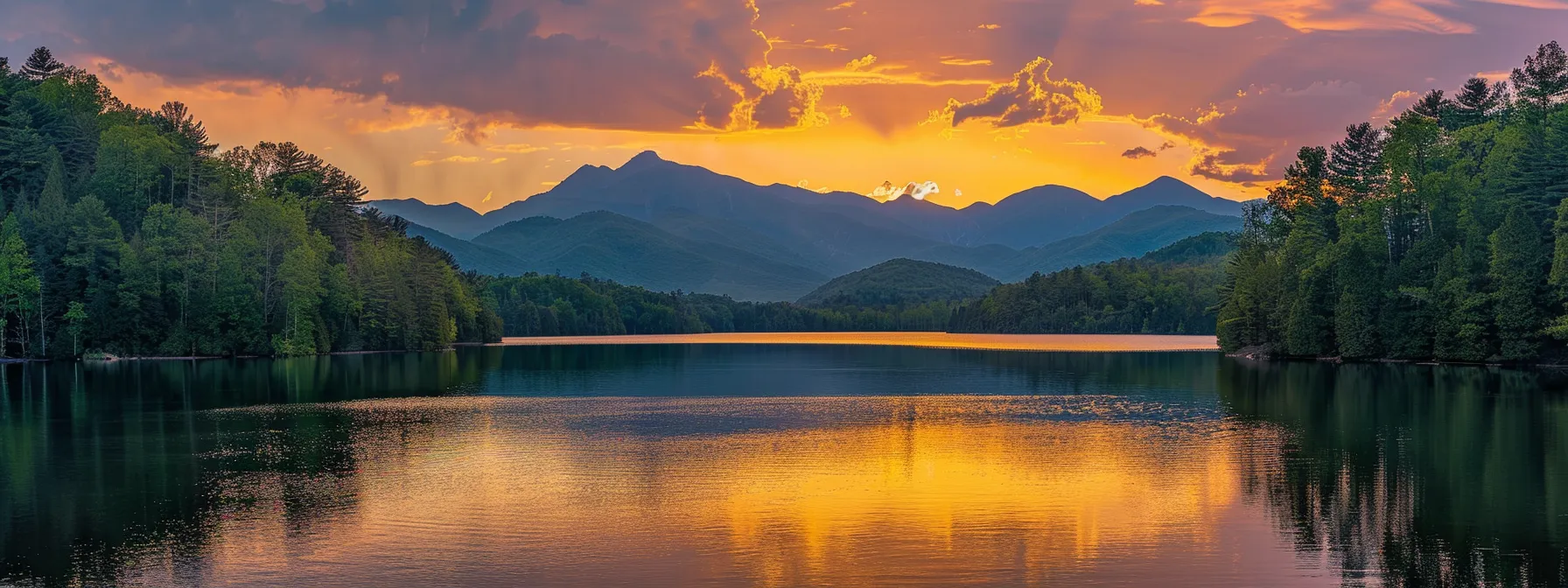 a majestic sunset bathes a tranquil lake in golden hues, reflecting silhouettes of towering mountains under a sky filled with vibrant orange and deep purple clouds. a majestic sunset bathes a tranquil lake in golden hues, reflecting silhouettes of towering mountains under a sky filled with vibrant orange and deep purple clouds.